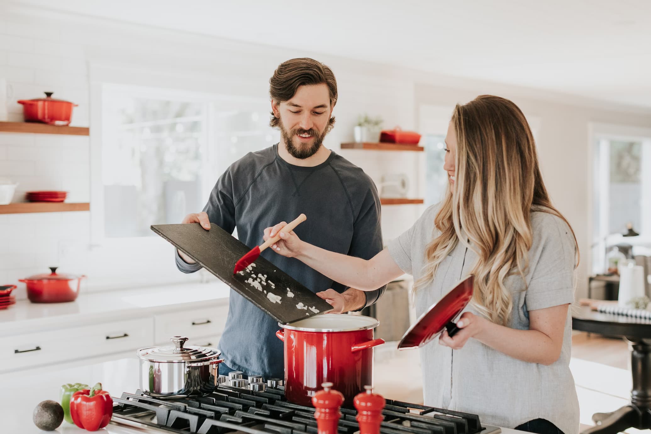 Couple preparing diner together inside a kitchen