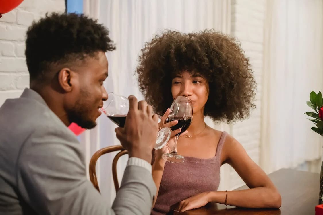 Couple sipping wine and looking at each other