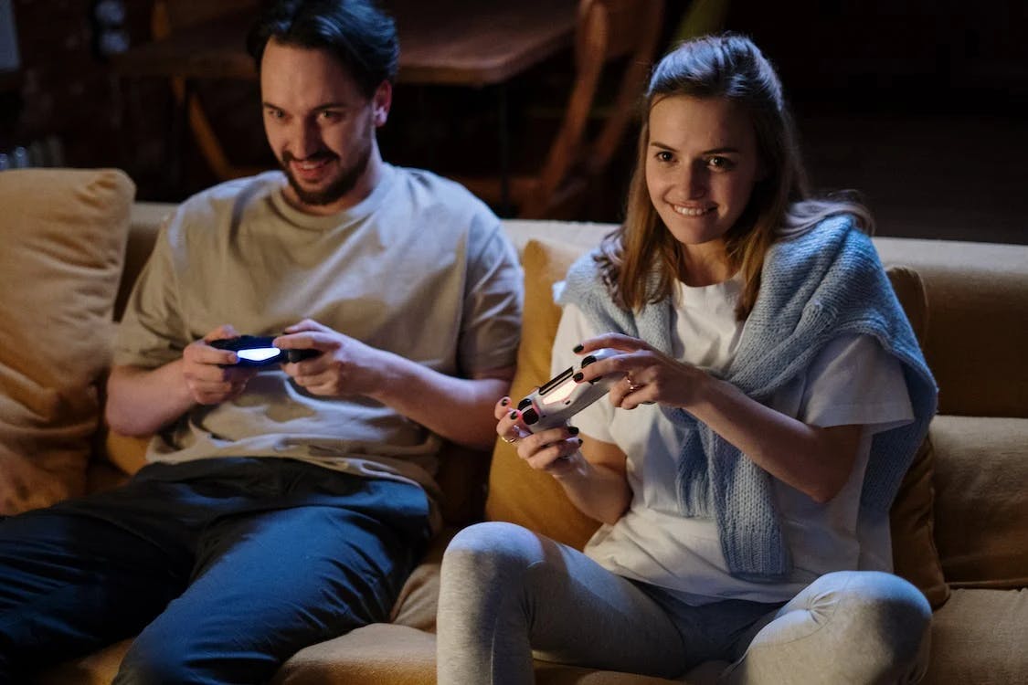 A couple playing games on the sofa