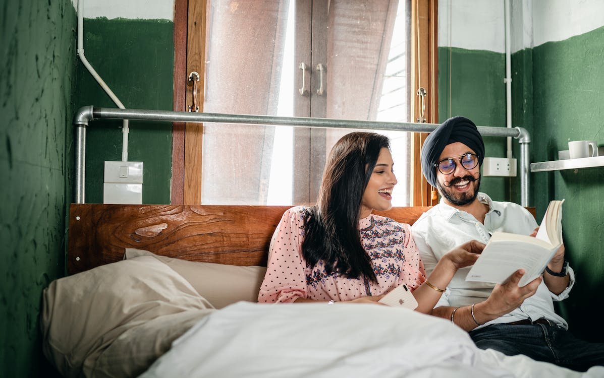 A couple reading a book in bed