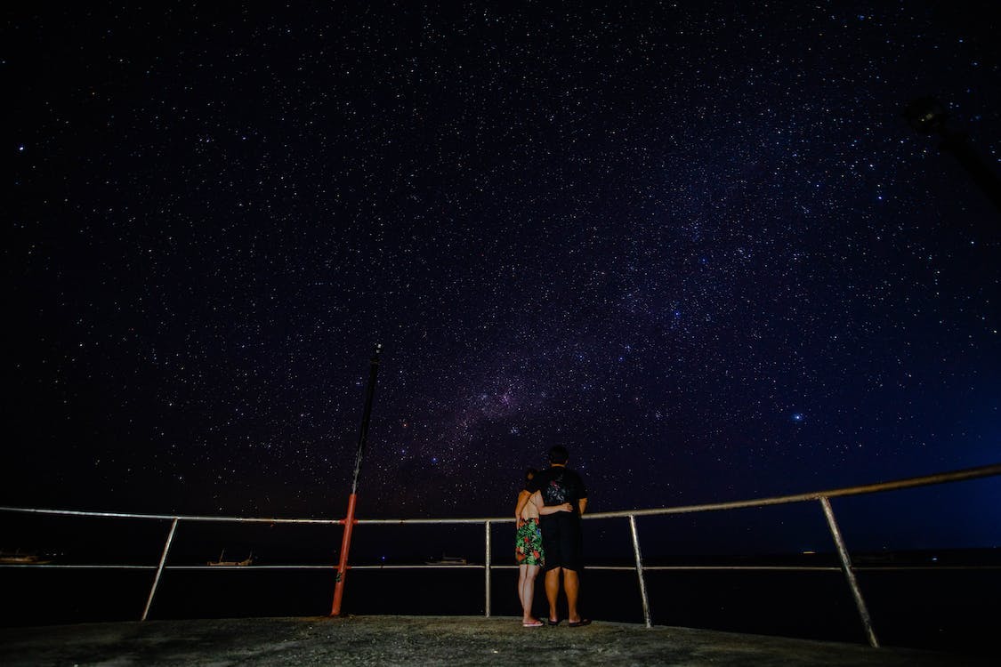 A couple looking at the stars at night